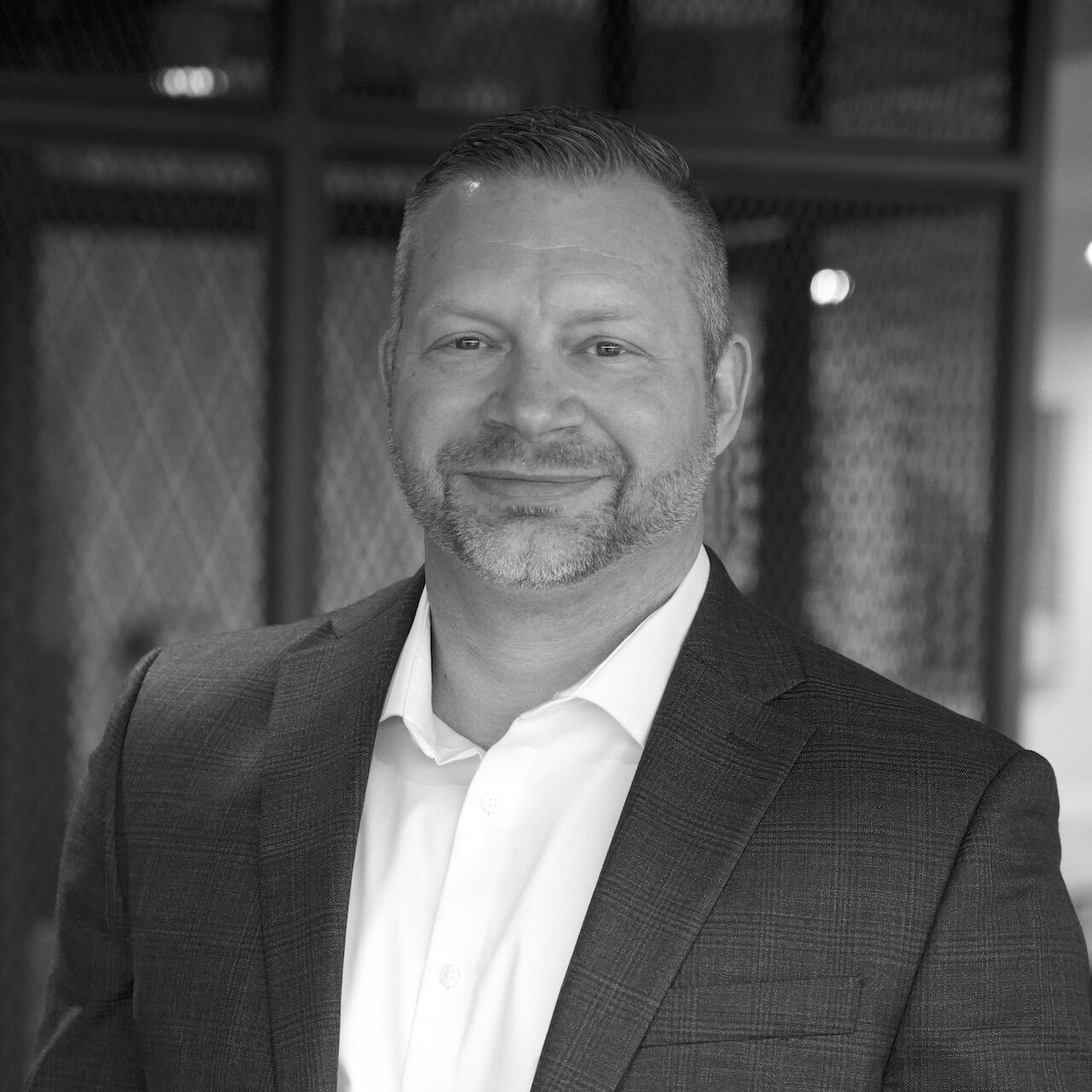 Headshot of Michael Siebenthall in white shirt and dark sportscoat