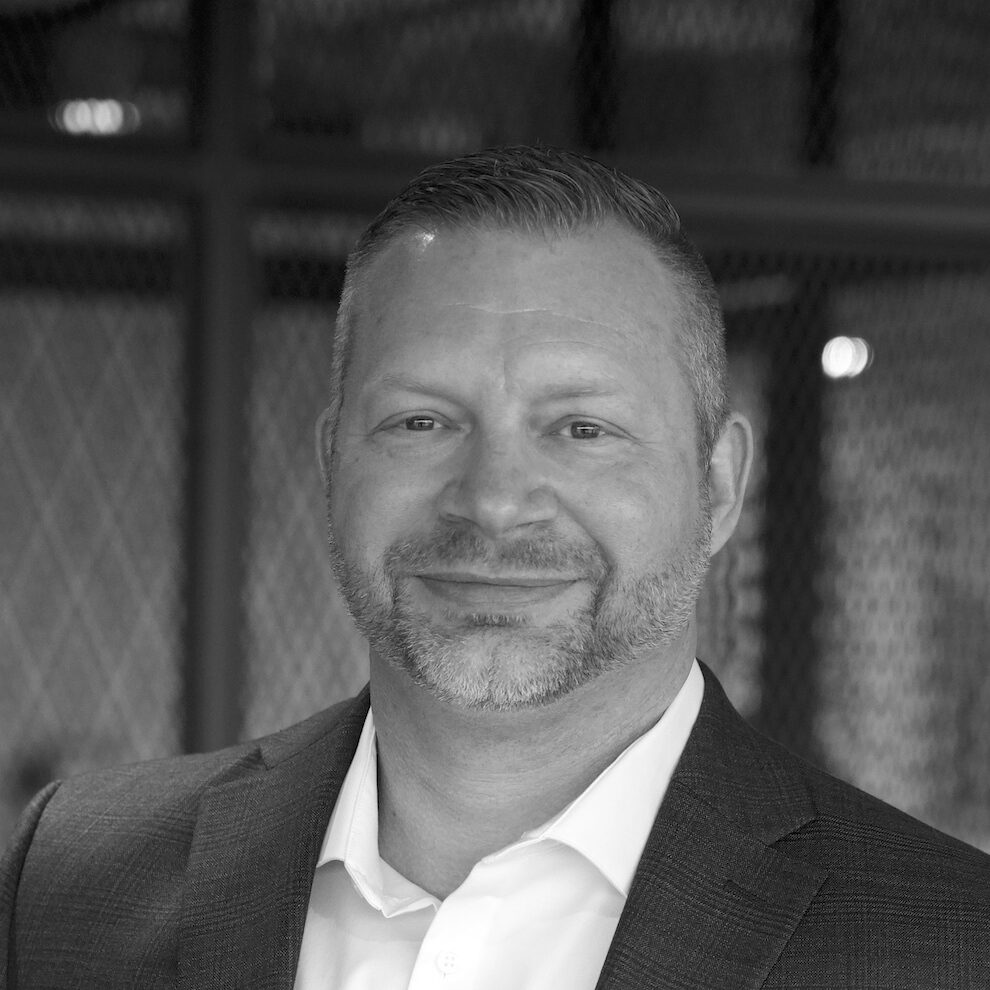 Headshot of Michael Siebenthall in white shirt and dark sportscoat